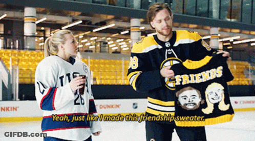 A Hockey Player Holding A Sweater That Says Friends On It GIF