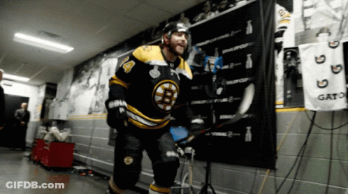 A Hockey Player In A Black And Yellow Jersey With The Number 4 On It GIF
