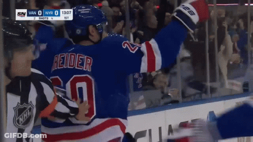 A Hockey Player In A Blue Jersey With The Number 20 On The Back GIF