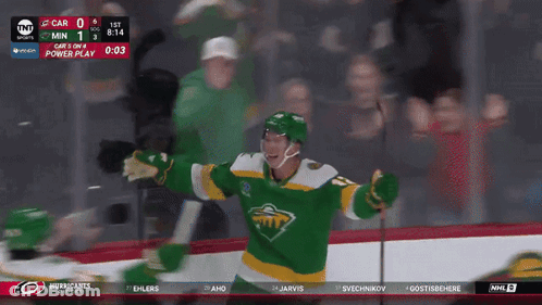 A Hockey Player In A Green And Yellow Jersey Celebrates GIF