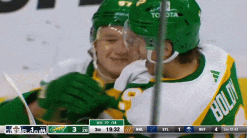 A Hockey Player In A Green Jersey With Bold On It GIF