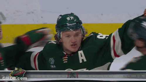 A Hockey Player In A Green Jersey With The Letter A On It GIF