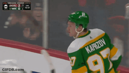 A Hockey Player In A Green Jersey With The Number 97 On It GIF