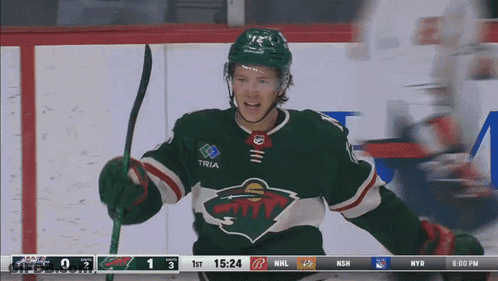 A Hockey Player In A Green Jersey With Tria On The Sleeve GIF