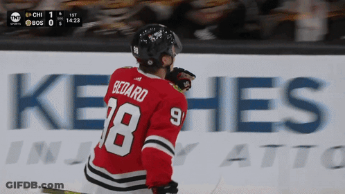A Hockey Player In A Red Jersey With The Number 18 On It GIF