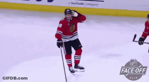 A Hockey Player In A Red Jersey With The Number 38 On It GIF