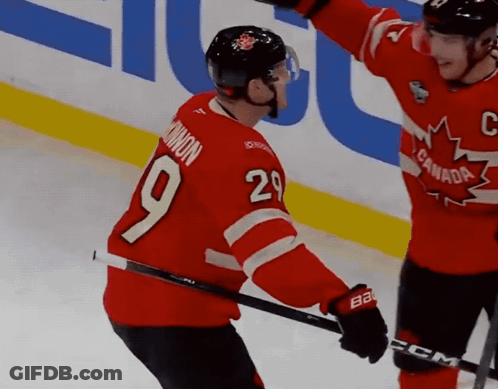 A Hockey Player In A Red Jersey With The Number 9 On It GIF