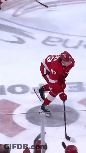 A Hockey Player In A Red Uniform With The Number 52 On His Back GIF