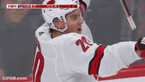 A Hockey Player In A White Jersey With The Number 20 On It GIF