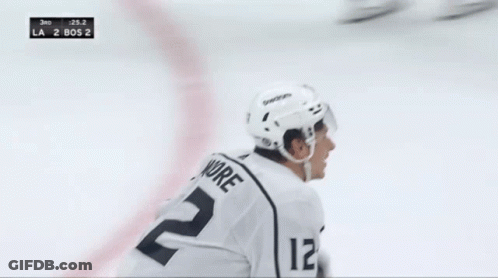 A Hockey Player In A White Jersey With The Number 22 On It GIF