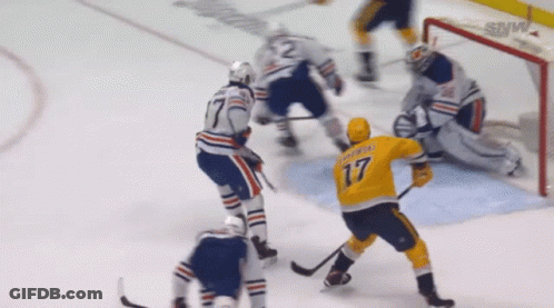 A Hockey Player In A Yellow Jersey With The Number 17 On The Back GIF