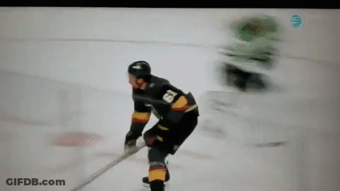 A Hockey Player Is Holding A Stick On The Ice GIF