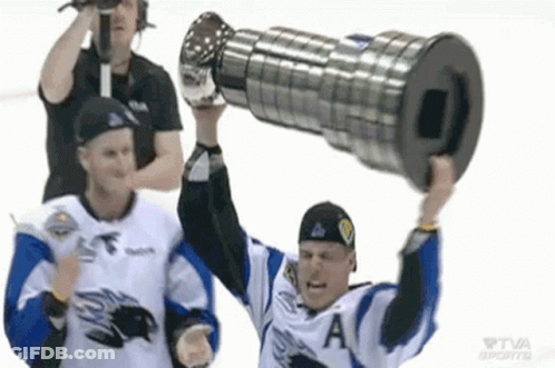 A Hockey Player Is Holding Up A Trophy While Another Player Watches . GIF