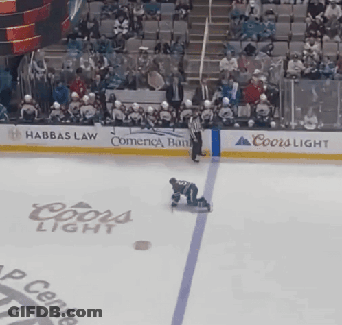 A Hockey Player Is Kneeling On The Ice In Front Of A Coors Light Advertisement GIF