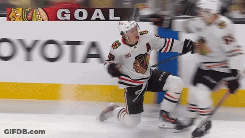 A Hockey Player Is Kneeling On The Ice In Front Of A Goal Banner GIF