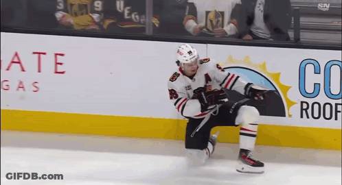 A Hockey Player Is Kneeling On The Ice In Front Of An Advertisement For Co Roof Gas GIF