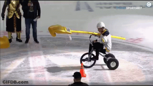 A Hockey Player Is Riding A Bike On The Ice With The Sportsnet Logo In The Background GIF