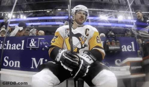 A Hockey Player Is Sitting In Front Of A Michael & Son Advertisement GIF