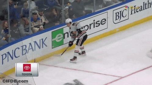 A Hockey Player Is Skating On The Ice In Front Of A Pnc Bank Banner GIF