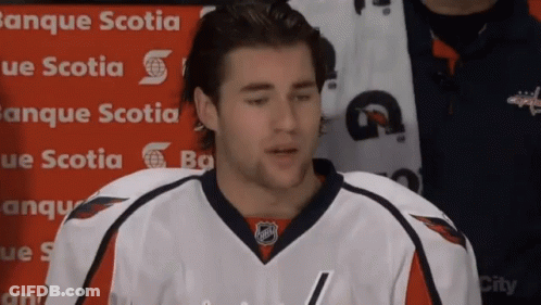 A Hockey Player Is Standing In Front Of A Banner That Says Banque Scotia GIF