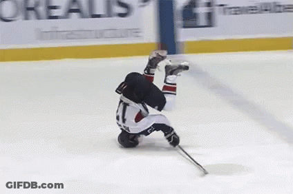 A Hockey Player Is Upside Down On The Ice In Front Of An Advertisement For Oreal GIF