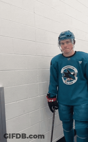 A Hockey Player Is Wearing A Blue Jersey That Says Property Of San Jose GIF