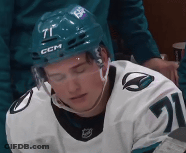 A Hockey Player Is Wearing A Helmet With The Number 71 On It GIF