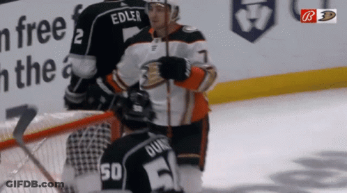 A Hockey Player Named Edler Is Kneeling Down On The Ice GIF