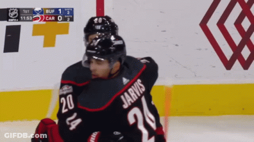 A Hockey Player Named Jarvis Is Hugging Another Hockey Player GIF