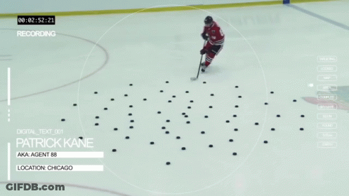 A Hockey Player Named Patrick Kane Is Standing On The Ice GIF