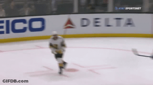A Hockey Player On The Ice With A Delta Sign In The Background GIF