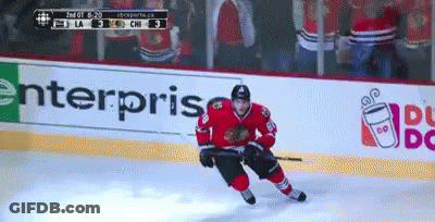 A Hockey Player On The Ice With A Dunkin Donuts Ad In The Background GIF
