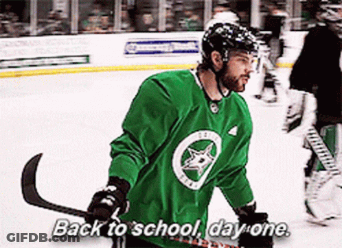 A Hockey Player Says Back To School Day One While Holding A Hockey Stick GIF