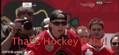 A Hockey Player Stands In Front Of A Crowd With The Words That 'S Hockey Baby On The Bottom GIF