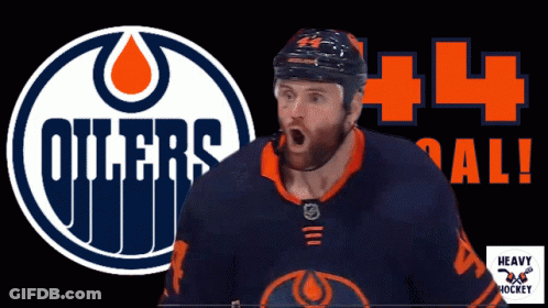 A Hockey Player Stands In Front Of A Logo For The Oilers GIF
