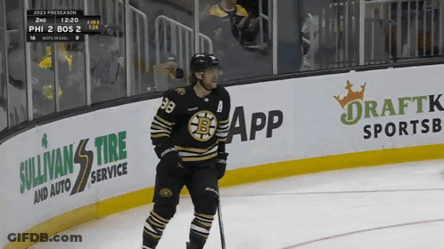 A Hockey Player Stands On The Ice In Front Of A Banner For Sullivan 'S Tire Service GIF