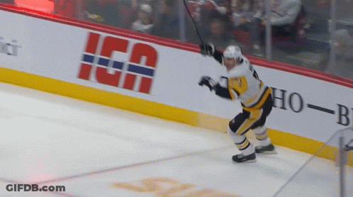 A Hockey Player Stands On The Ice In Front Of A Banner That Says " Ica " GIF
