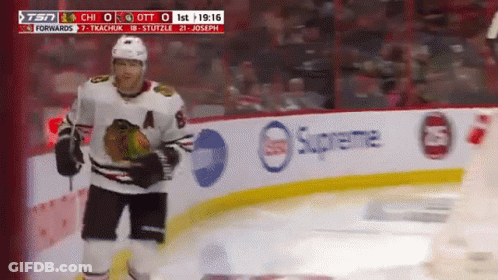 A Hockey Player Stands On The Ice In Front Of A Supreme Banner GIF