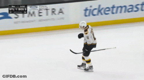 A Hockey Player Stands On The Ice In Front Of A Symera Sign GIF