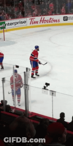 A Hockey Player Stands On The Ice In Front Of A Tim Hortons Advertisement GIF