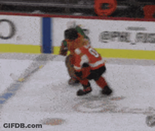 A Hockey Player Stands On The Ice In Front Of An Advertisement For Bhhub GIF
