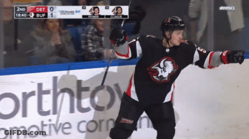 A Hockey Player Stands On The Ice In Front Of An Advertisement For Northtown GIF
