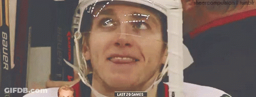 A Hockey Player Wearing A Bauer Helmet Is Smiling GIF