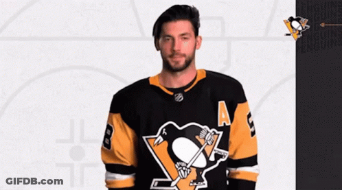 A Hockey Player Wearing A Black And Yellow Jersey With The Number 8 On It GIF
