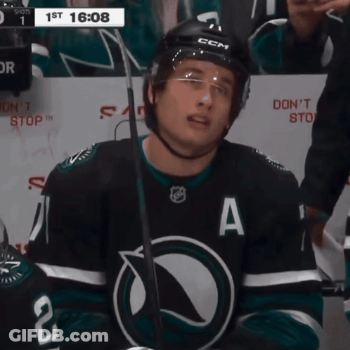 A Hockey Player Wearing A Black Jersey With The Letter A On It GIF