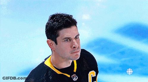 A Hockey Player Wearing A Black Jersey With The Letter C On It GIF