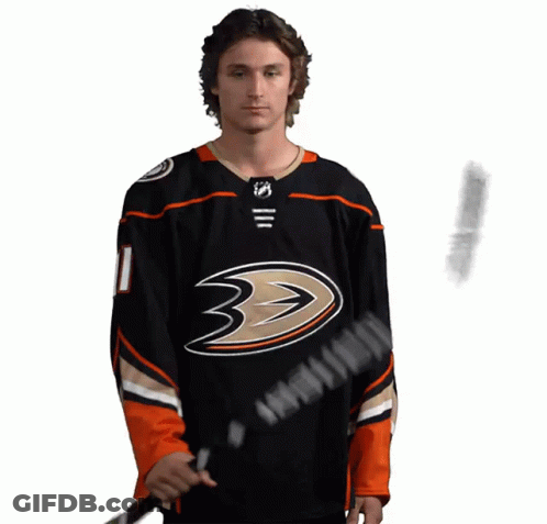 A Hockey Player Wearing A Black Jersey With The Number 11 On It GIF