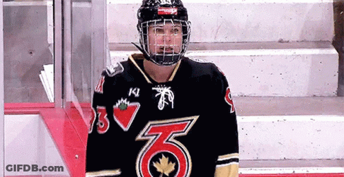 A Hockey Player Wearing A Black Jersey With The Number 6 On The Front GIF