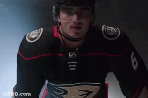 A Hockey Player Wearing A Black Jersey With The Number 8 On The Sleeve GIF
