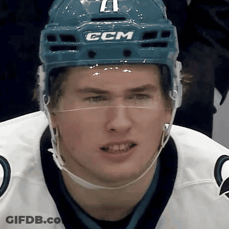 A Hockey Player Wearing A Blue Helmet With The Letters Ccm On It GIF